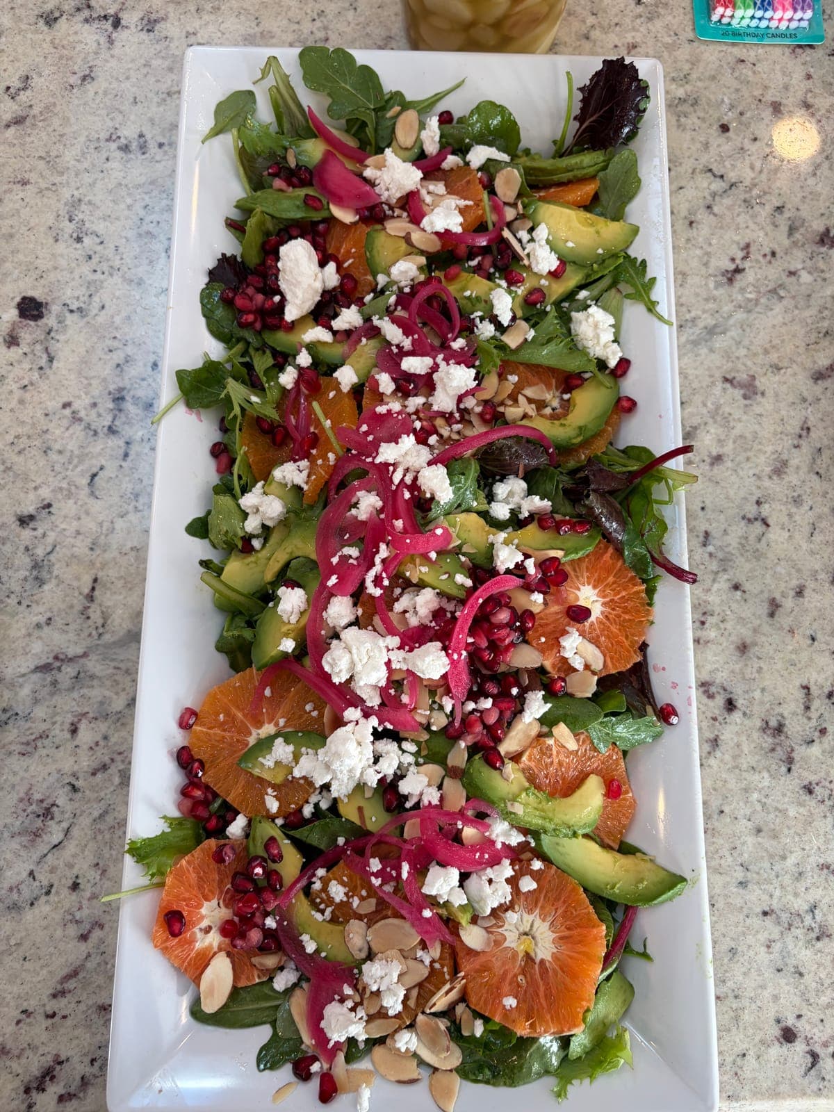 Fresh salad with blood orange, avocado, pomegranate, feta and almonds