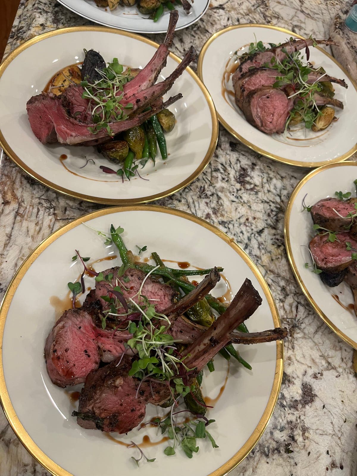 Plated rack of lamb with green beans and roasted potatoes at a private dinner in San Diego